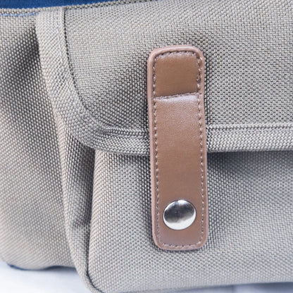Leather snap pouch on dog backpack, stylish storage feature for outdoor gear
